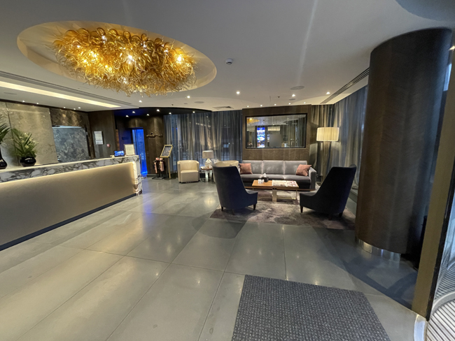 a lobby with a chandelier and chairs