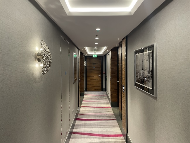 a hallway with a carpet and lights