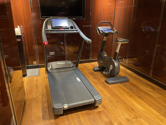 a treadmill and exercise bike in a room