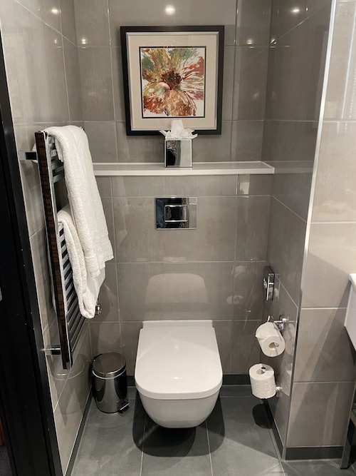 a bathroom with a picture on the wall