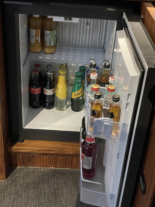 a refrigerator with bottles of drinks