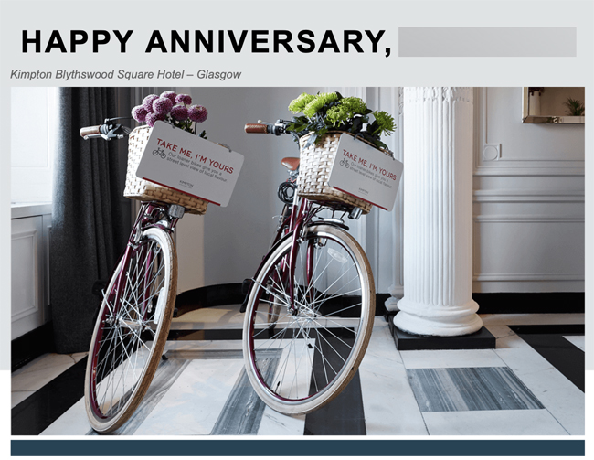 two bicycles with baskets of flowers and a sign