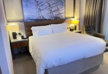 a bed with a picture of a ship on it