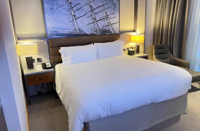 a bed with a picture of a ship on it