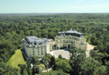 a large white building surrounded by trees