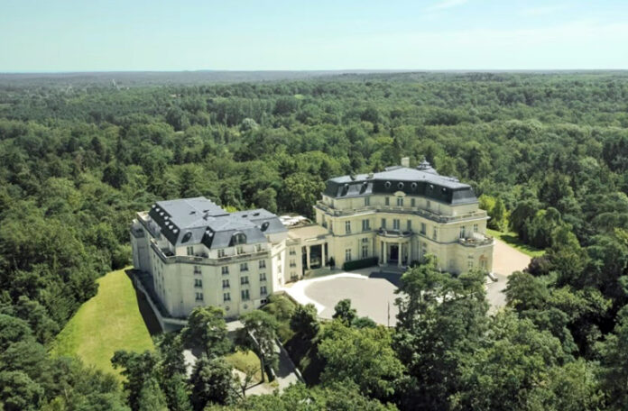 a large white building surrounded by trees