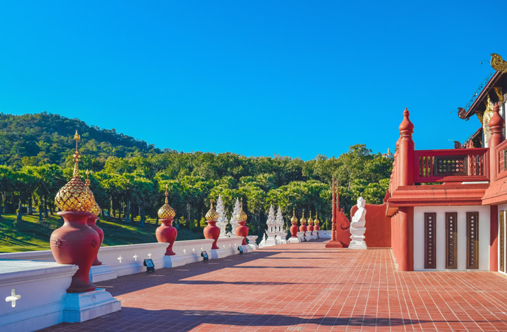 a red and white building with statues on the side