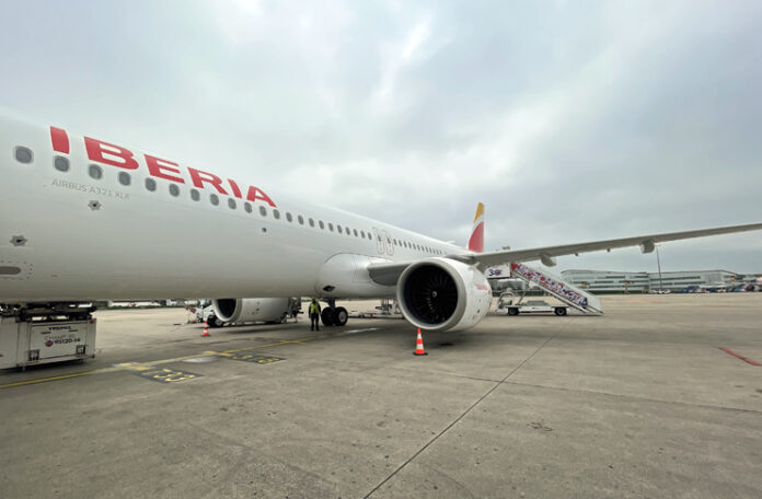 a large white airplane with red writing on it