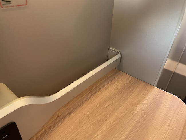 Iberia A321XLR Business Class seat shelf with protective bar.