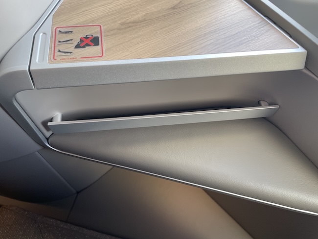 Iberia A321XLR Business Class seat storage with protective bar.