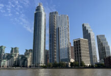 a group of tall buildings next to a body of water