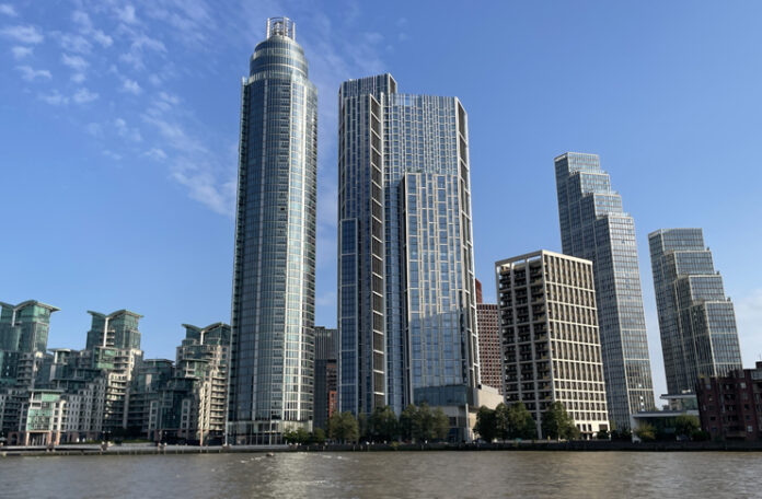 a group of tall buildings next to a body of water