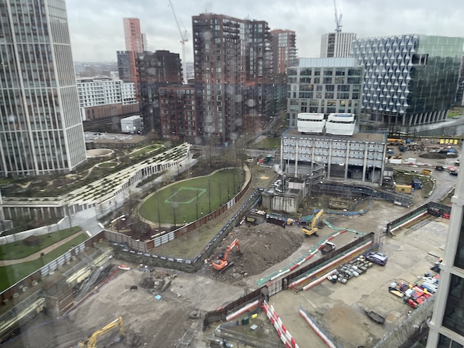 a construction site with buildings and cranes