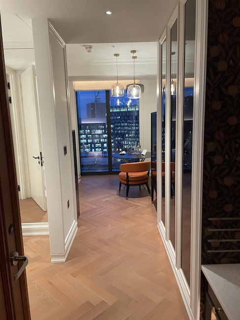 a hallway with a chair and a table