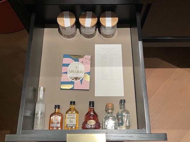 a shelf with bottles and a book