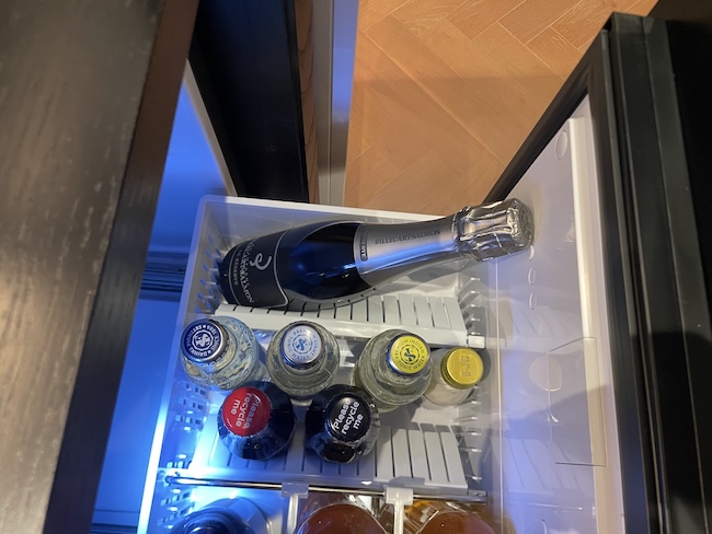 a bottle of champagne in a mini fridge