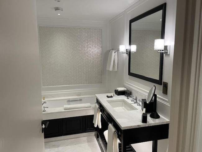 a bathroom with a mirror and a bathtub