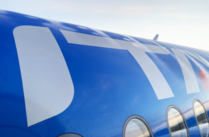 a blue and white airplane with windows