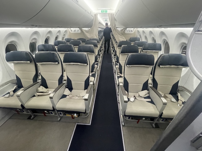 a man standing in a row of seats