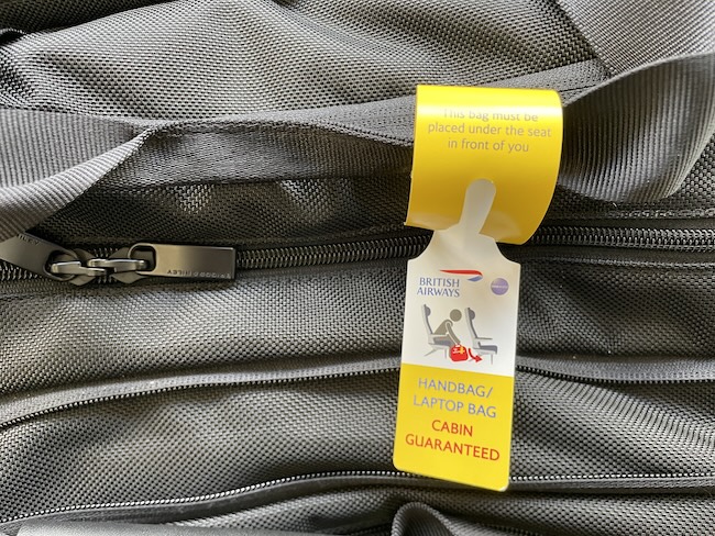 a luggage bag with a yellow and white tag