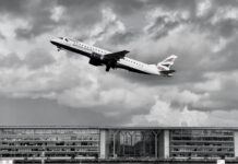 a plane flying over a building
