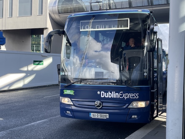 a blue bus parked on a street