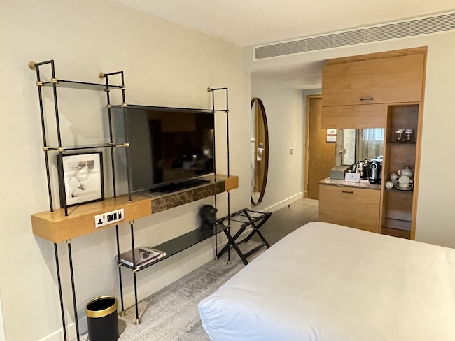 a room with a tv and a mirror