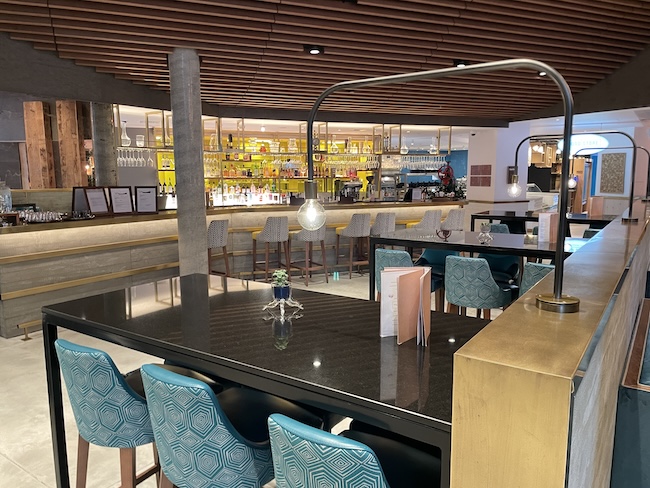 a restaurant with a bar and chairs