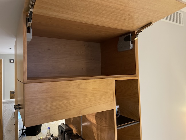 a wooden cabinet with a shelf