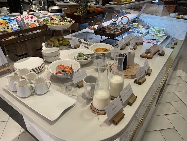 a buffet table with plates and bowls of food