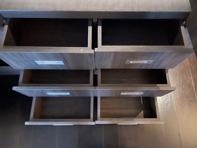 a wooden drawers with a drawer in the middle