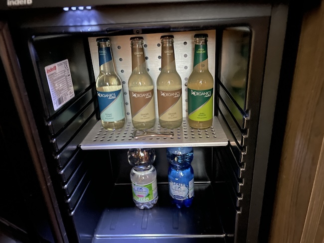 a mini fridge with bottles of beverage