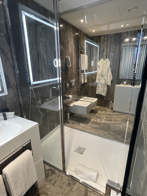 a bathroom with a glass shower and a sink