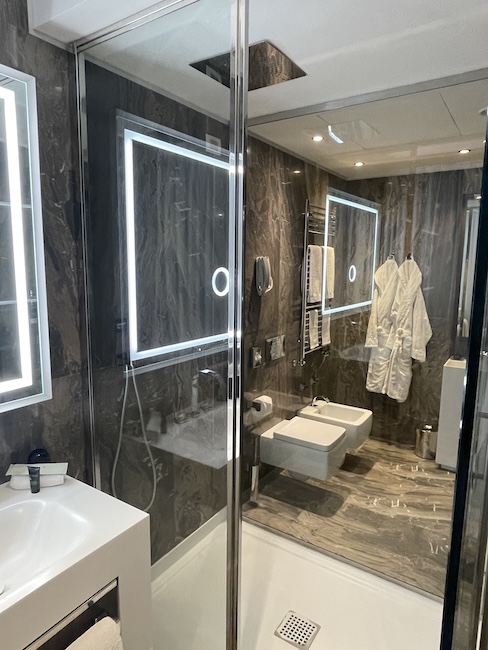 a bathroom with a glass shower door