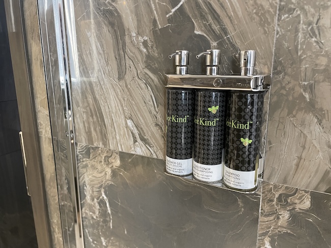 a group of hair sprays on a shelf