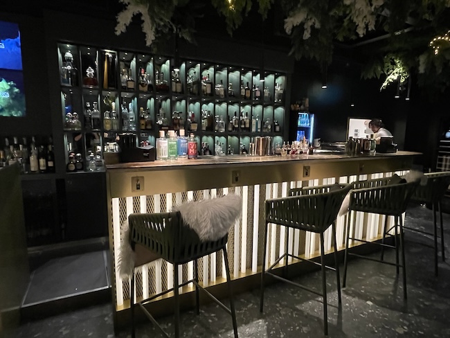 a bar with bottles and shelves