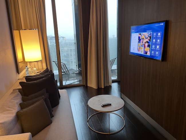a living room with a television on the wall