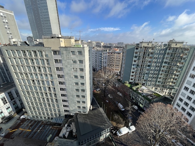 a group of buildings with cars parked in front of them