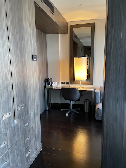 a room with a desk and a mirror