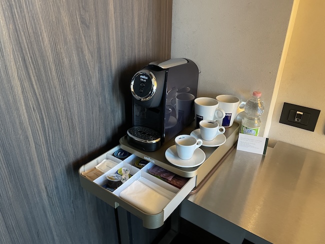 a coffee machine and cups on a tray