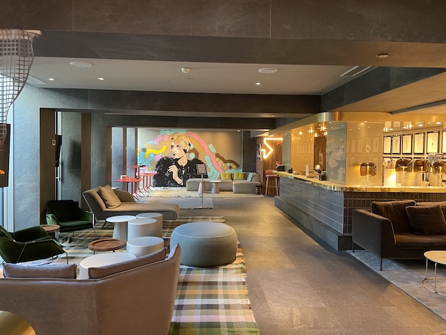 a room with a bar and couches