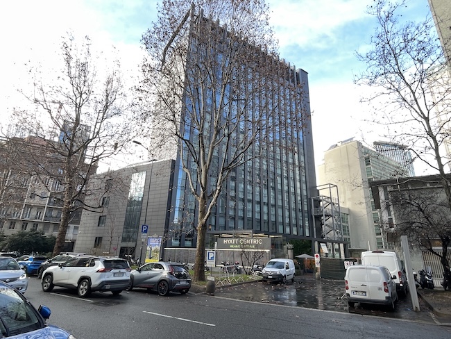a building with cars parked on the side of the road
