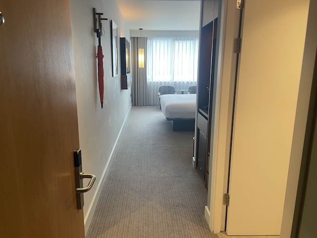 a hallway with a bed and a door