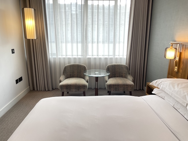a bed and chairs in a room