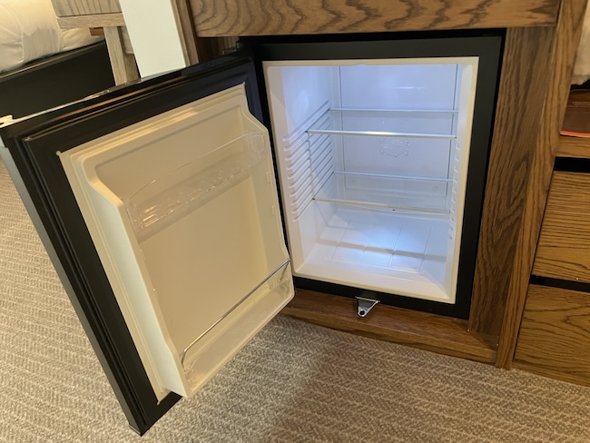 a small refrigerator with a door open