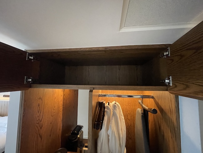 a closet with a white robe from it