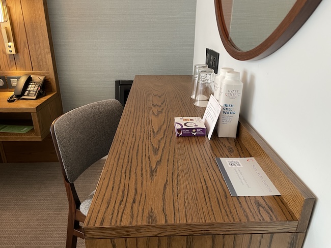 a chair and a desk with a mirror