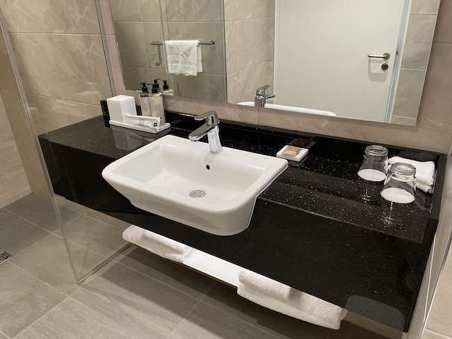 a bathroom with a sink and mirror