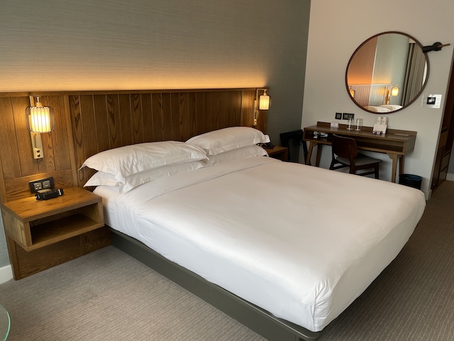 a bed with a round mirror