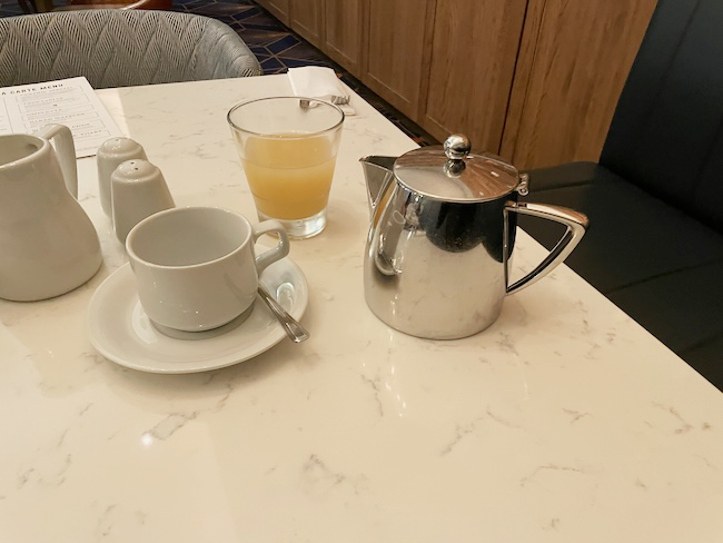 a teapot and a glass on a table
